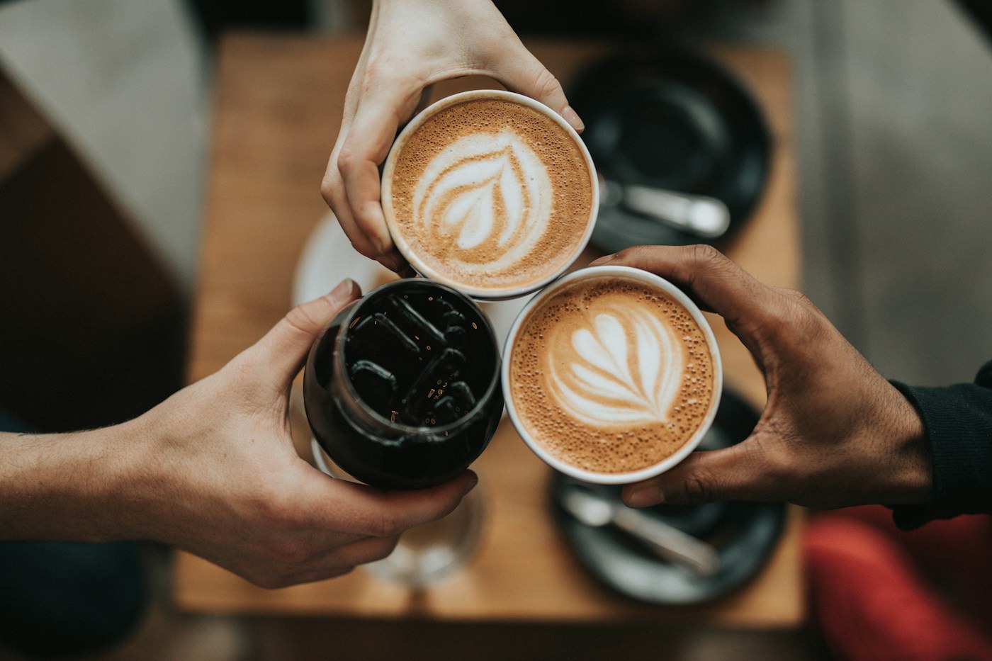 Cups of coffee brought together over a table